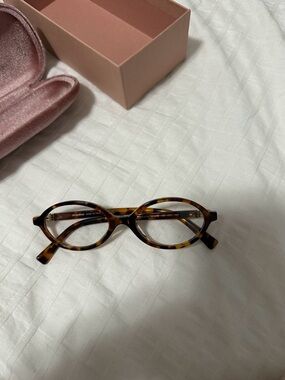 MIU MIU OVAL EYEGLASSES.